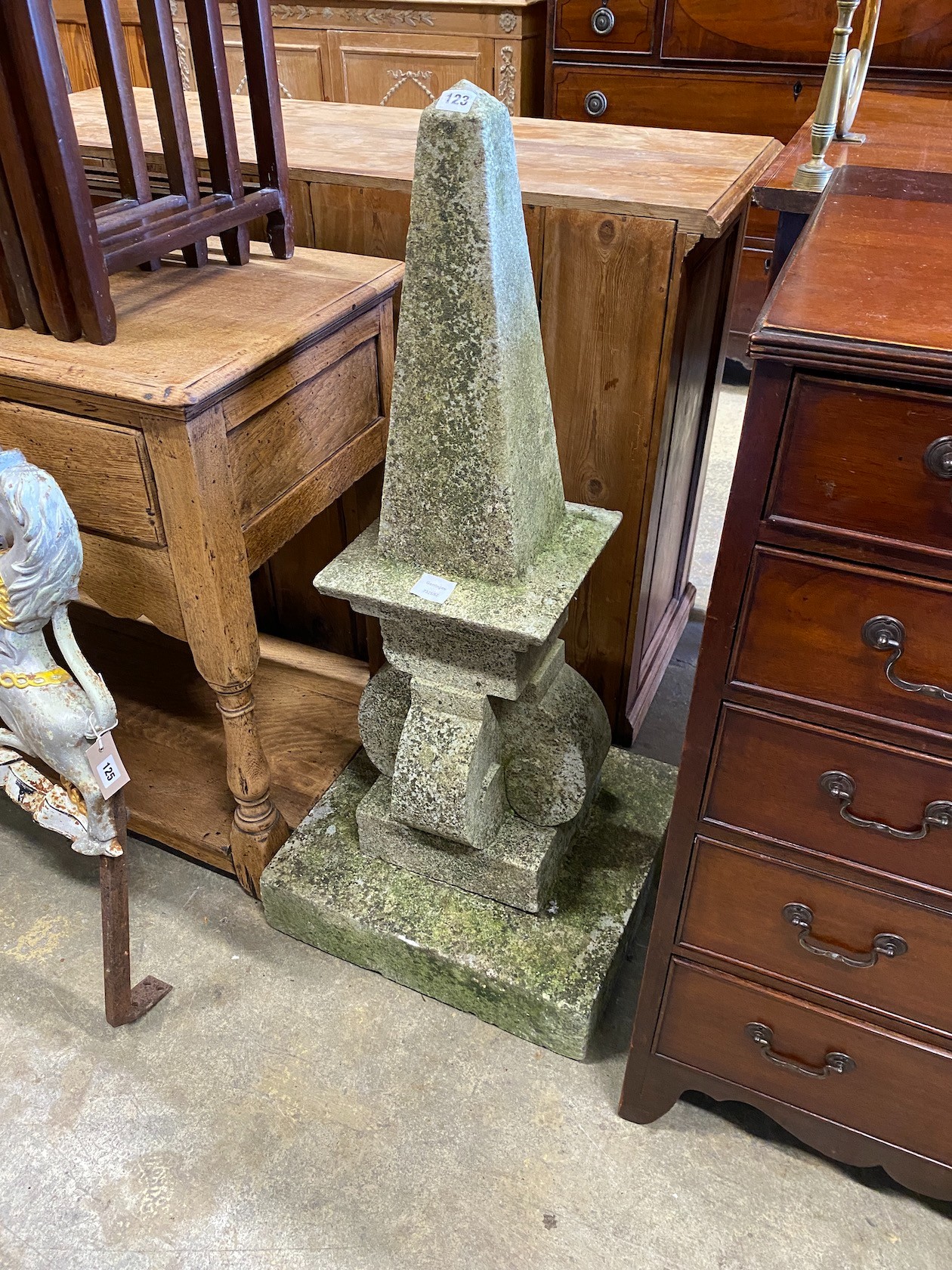 A carved natural stone obelisk finial, on a square plinth, height 102cm